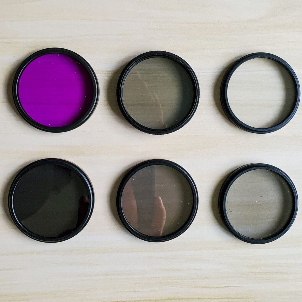 6 lens filters, Top Row (right to left): fld, cpl, uv. Bottom Row(right to left): ND 8, ND 4, ND 2