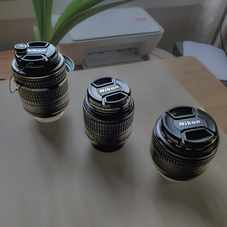 3 DSLR camera lenses, back to front: 55-200mm, 18-55mm and 50mm