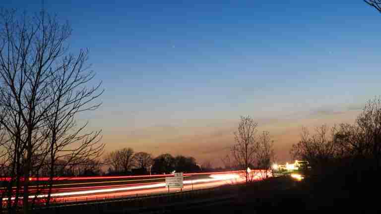 Car headlights showing as a streak of light because of long exposure shutter technique